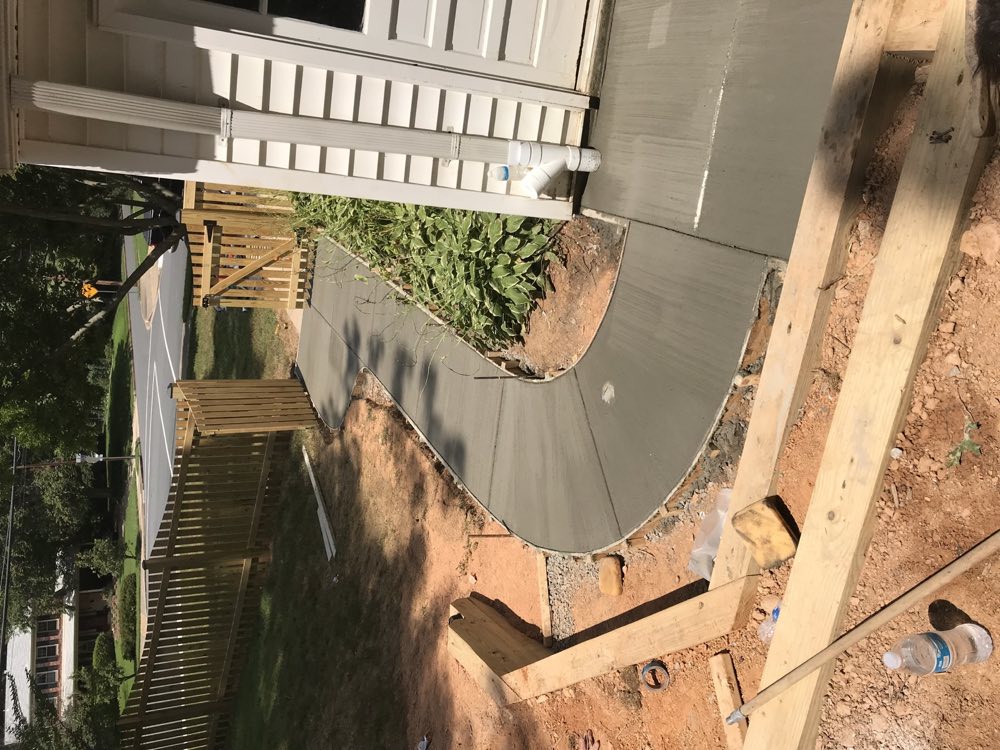 Curved residential concrete walkway during installation