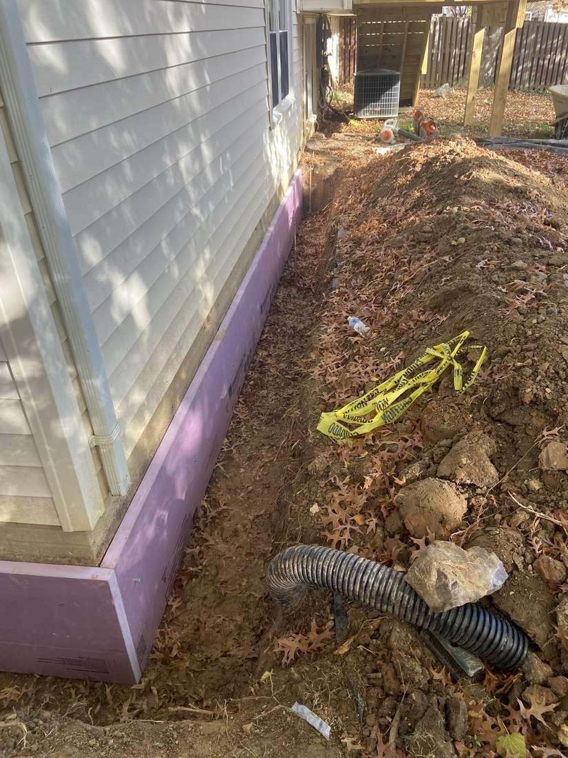 Exterior foundation exposed for water-management and protective work