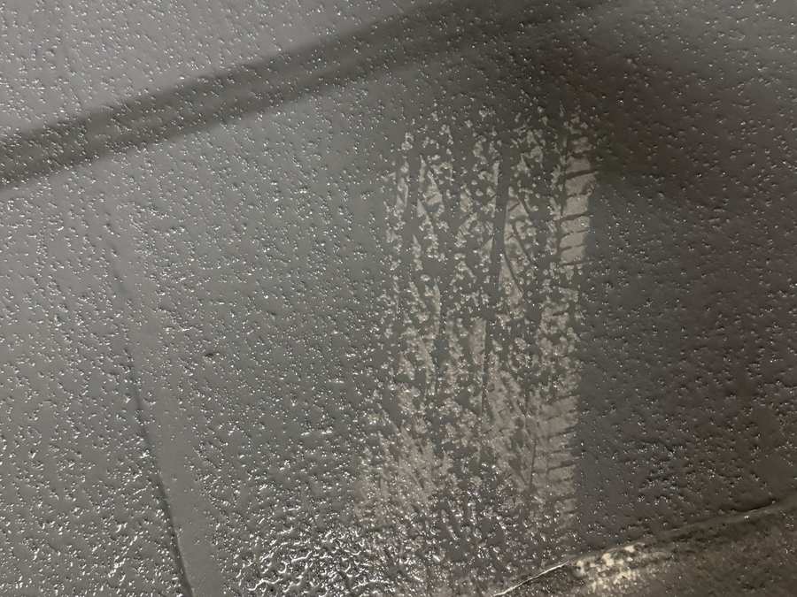 Close view of a gray traffic-surface coating across a parking garage floor