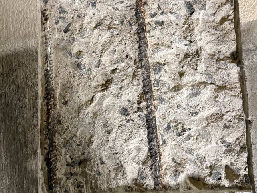 Localized opening in a concrete parking garage floor exposing the condition at the selected repair area